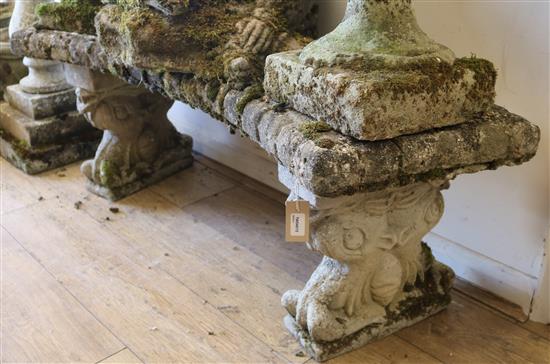 A reconstituted stone shaped garden bench W.108cm